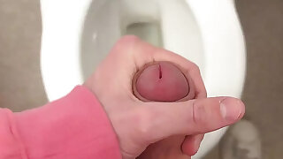 Twink wixes his big cock on the toilet