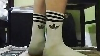 Cute twink showing his dirty white socks, while he listening to music and singing.